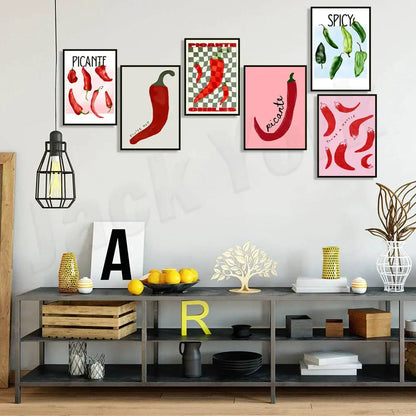 A set of five decorbites chili pepper art prints in black frames featuring red and green peppers with spicy text designs