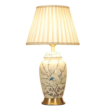 Decorbites™ cream ceramic table lamp with hand-painted blue birds pink blossoms and beige pleated shade with gold trim