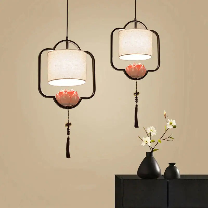 Black-framed decorbites cloth chandelier with cream fabric shades and pink lotus blossoms for bedroom and dining room lighting