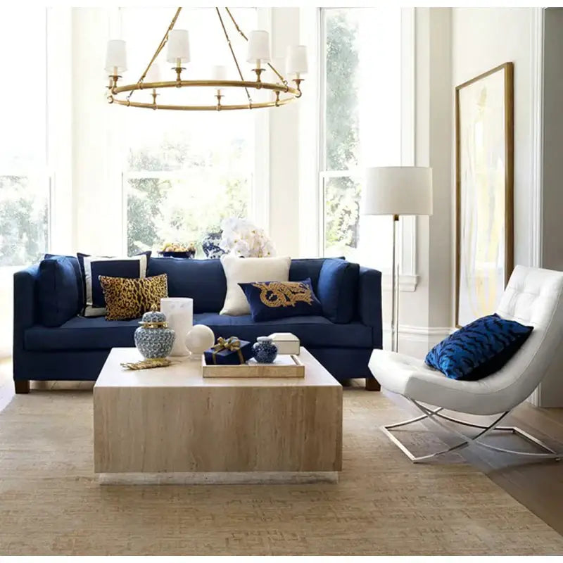 Navy blue sofa with DecorBites™ gold dragon embroidery lumbar pillow cover and wooden coffee table in front