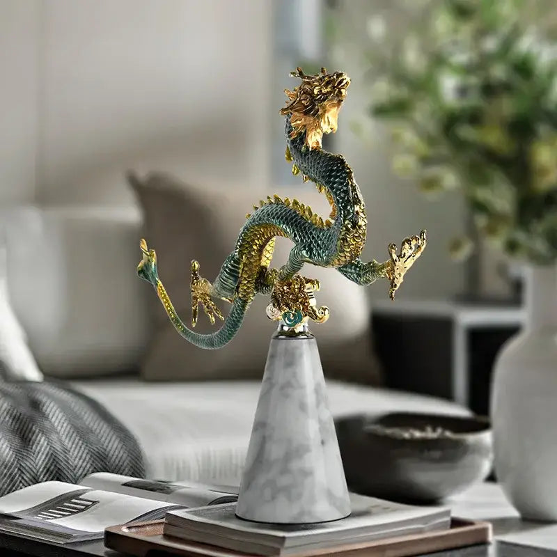 A detailed teal and gold serpentine dragon figurine on white marble pedestal chinese dragon decorbites chinese dragon phoenix