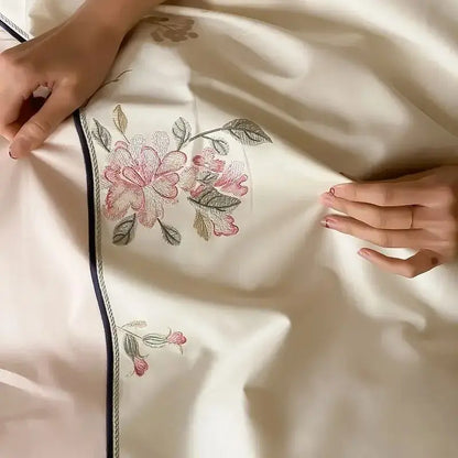 Cream-colored satin bedding set with delicate pink and green chinese flowers embroidery and navy blue decorbites chinese flowers border