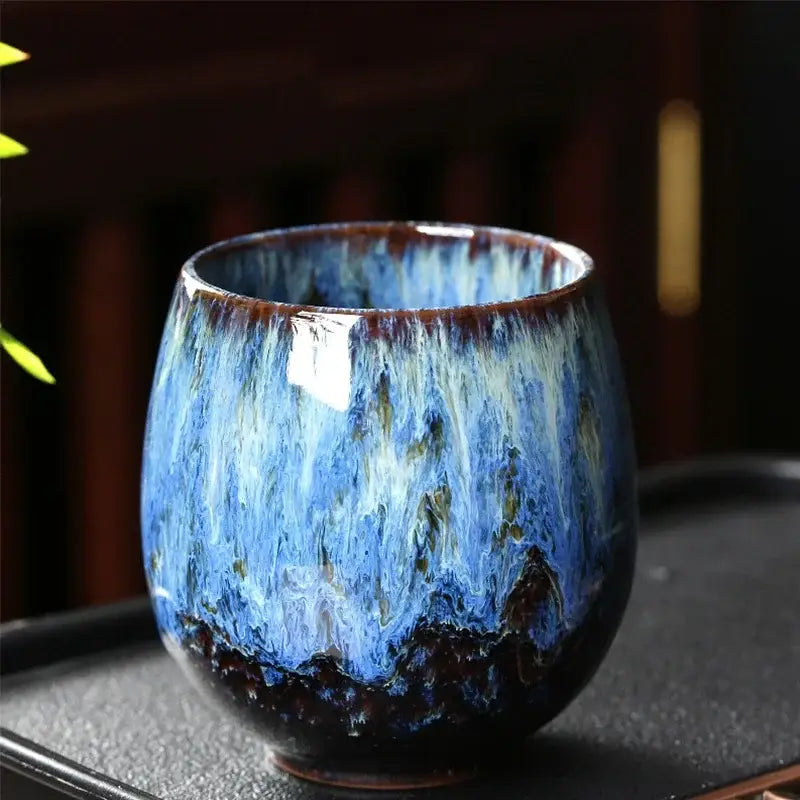 A handcrafted ceramic coffee cup from decorbites™ featuring vibrant blue swirling glaze in a 250ml elegant set
