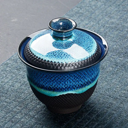 A ceramic teacup with lid featuring textured blue and black glaze in the DecorBites Chinese kung fu tea set