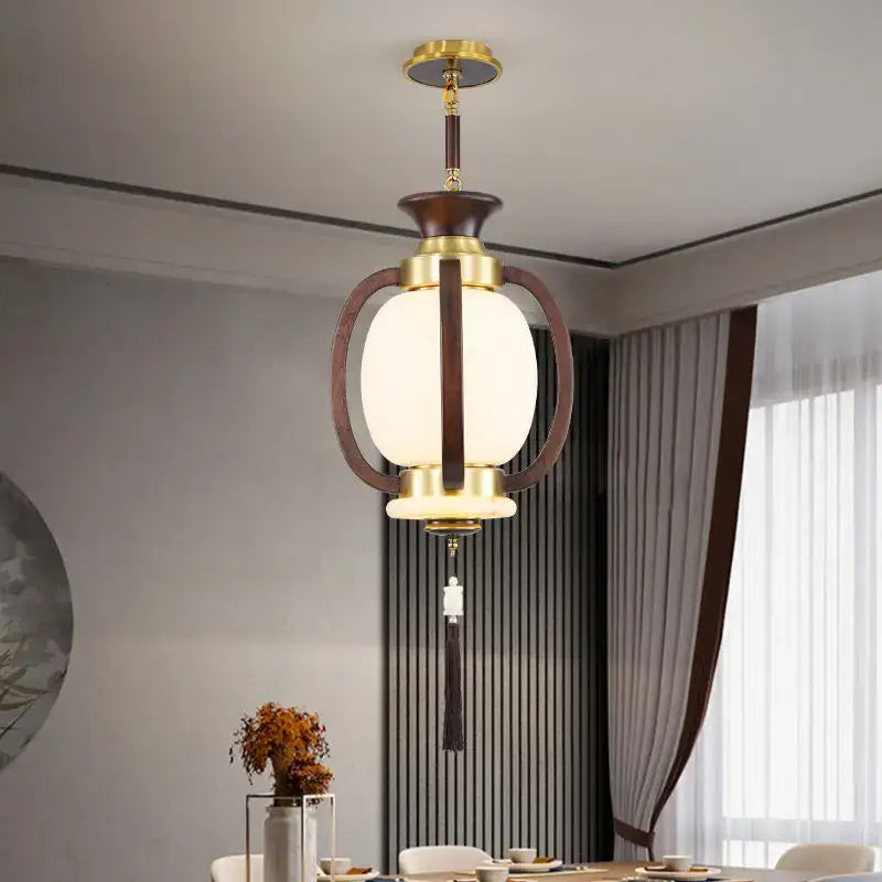 Decorbites chinese lantern chandelier with brass and dark wood frame, oval frosted glass shade, and decorative tassel