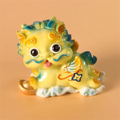 A charming yellow ceramic mythology lion figurine with blue and green accents holding a golden coin for luck and wealth