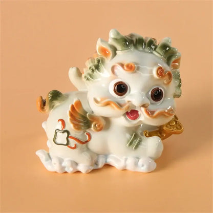A white ceramic mythology lion figurine with green and orange accents from DecorBites™ for luck and protection