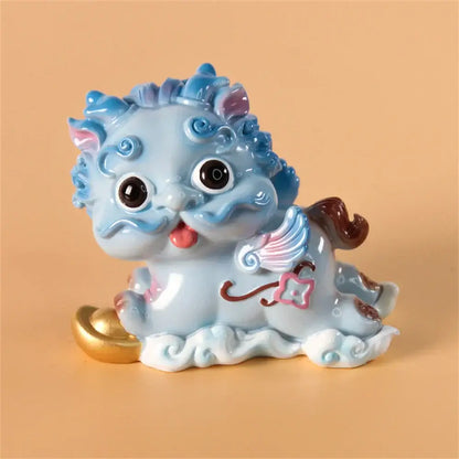 A charming light blue ceramic mythology lion figurine with pink accents and decorative wings for luck and protection