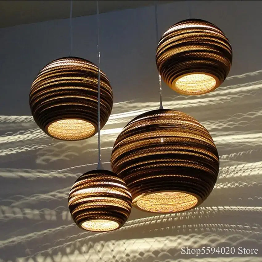 DecorBites™ three brown corrugated paper pendant lights with warm glowing interior for restaurant and living room use