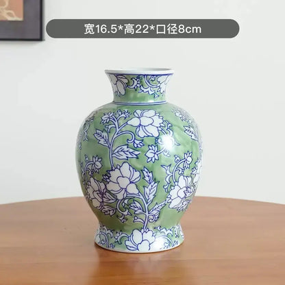A green porcelain vase with intricate white and blue floral patterns from DecorBites™ Chinese retro blue porcelain vase