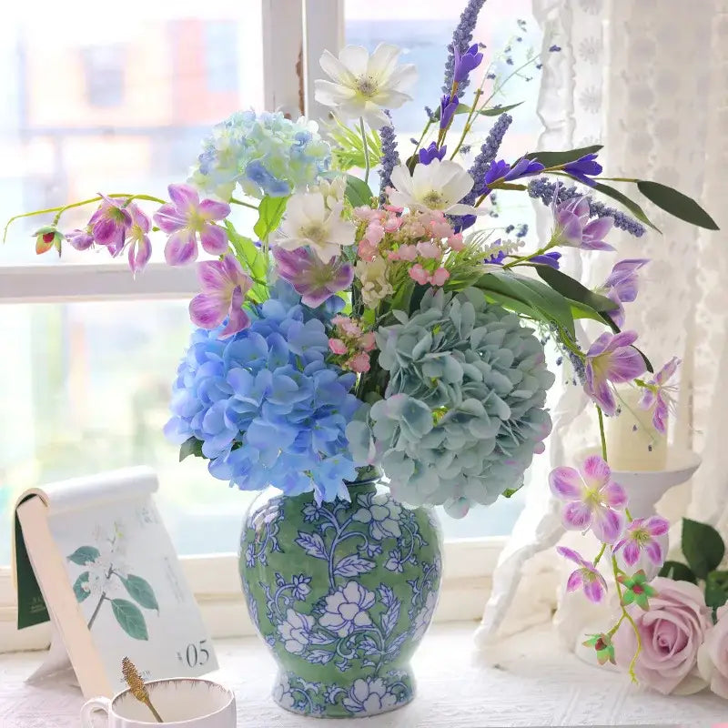 A decorbites chinese retro blue and white porcelain vase holds artificial hydrangeas and orchids in vibrant colors