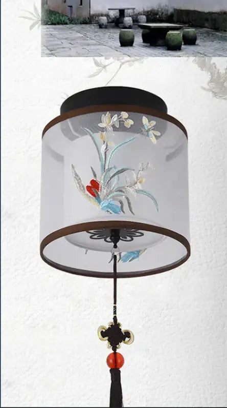 A decorbites chinese style ceiling lamp with a translucent cylindrical design embroidered with pastel flowers and birds