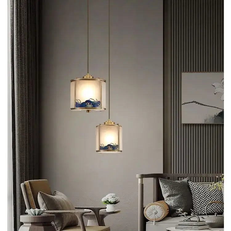Two elegant brass-framed copper pendant lights with blue wave patterns for living space and bedroom decor