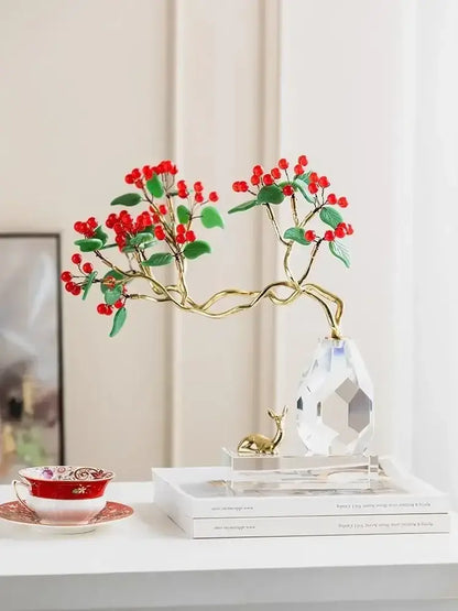 A delicate gold-toned decorative branch with red berries and green leaves on a crystal base in decorbites chinese style crystal ornaments