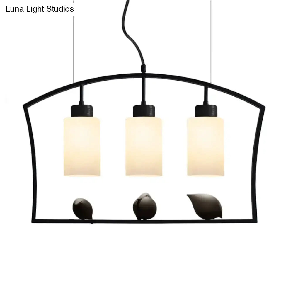 Black DecorBites™ cylinder island light fixture with three frosted glass shades and decorative bird figurines ceiling lamp