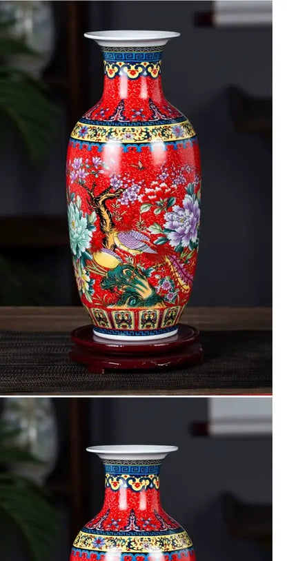A vibrant red porcelain enamel colored vase by decorbites featuring hand-painted floral and bird motifs with gold trim