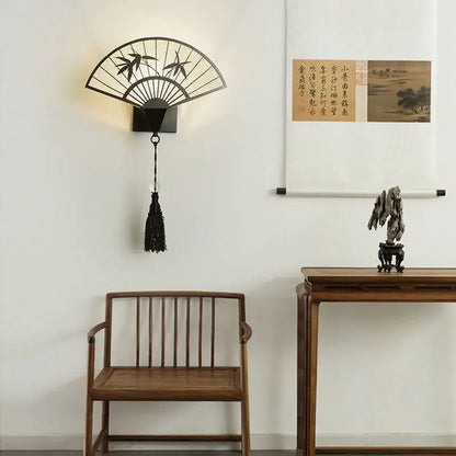 Black metal fan-shaped wall sconce with bamboo design and tassel in iron art decorbites chinese style for living room