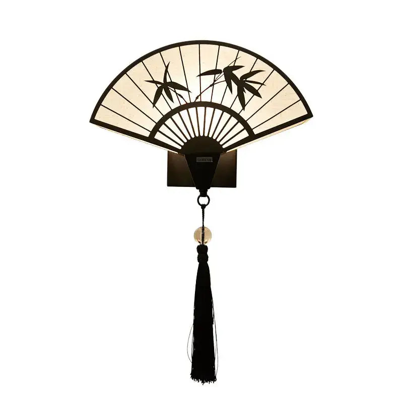Elegant black and cream iron art wall sconce with bamboo leaf design and tassel by DecorBites Chinese style for living spaces