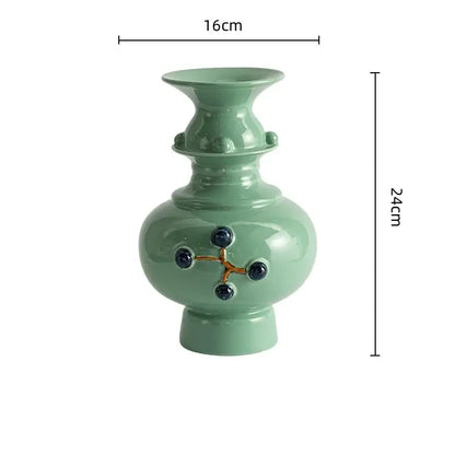 DecorBites™ retro ceramic vase in light green with dark blue accents and gold lines for elegant home decor