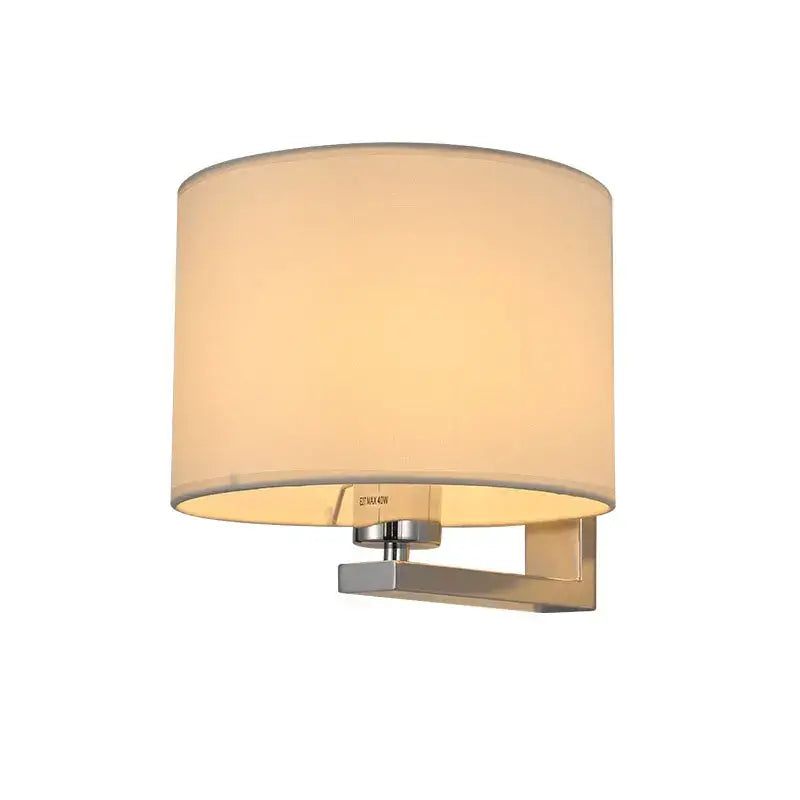 Cream-colored cylindrical wall lamp with warm cloth cover mounted on chrome sconce for bedroom living room use