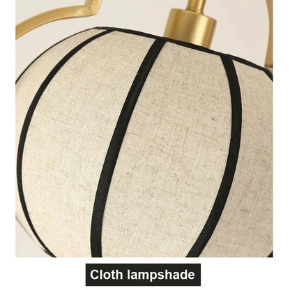 Beige linen teahouse lantern chandelier with black vertical stripes and gold-toned metal fixture for elegant lighting