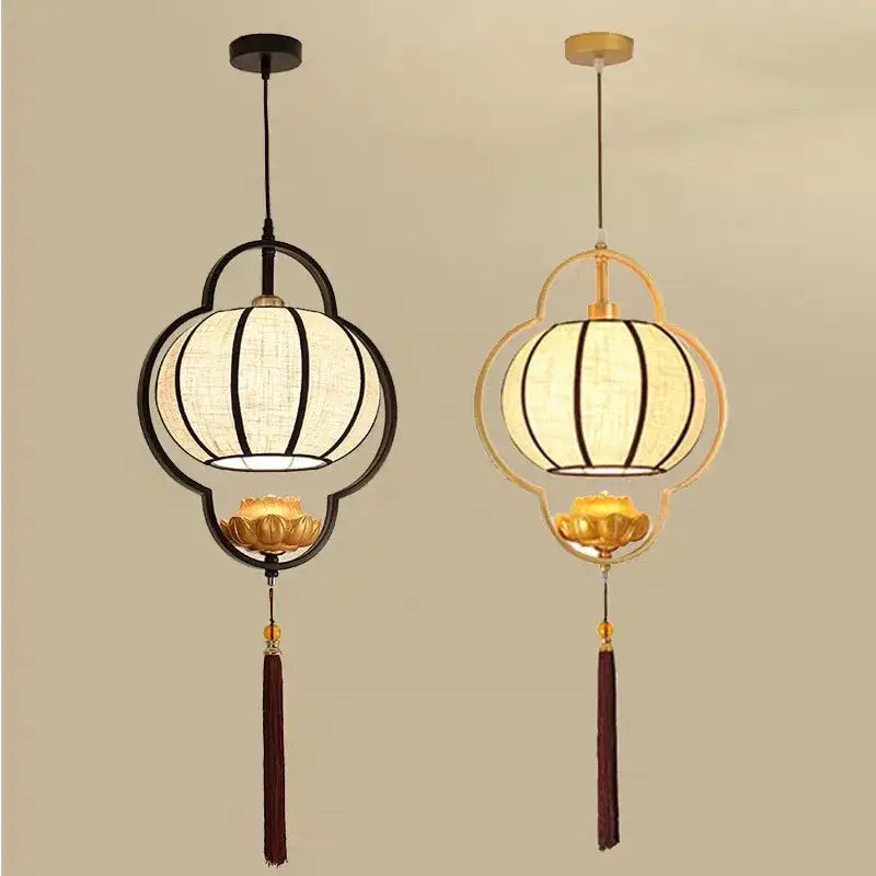 Two elegant decorbites™ teahouse lantern chandeliers with black and gold metal frames, white fabric shades, lotus bases, and tassels