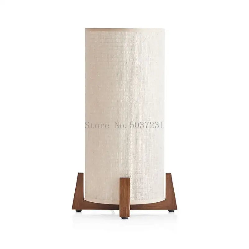 Cream-colored cylindrical lampshade with textured fabric on a zen wooden floor lamp by DecorBites for living room use