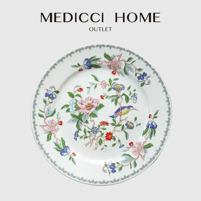 A delicate white porcelain decorbites chinoiserie floral birds dinner plate with vibrant pink blue red and green motifs