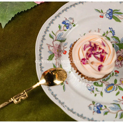 A delicate white porcelain decorbites chinoiserie floral birds dinner plate with intricate blue pink and green patterns