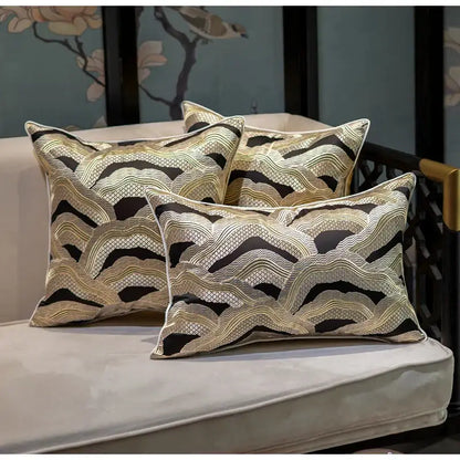 Three elegant rectangular throw pillows with decorbites chinoiserie golden embroidered cushion cover on light sofa