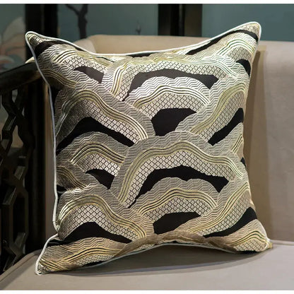 Square cushion cover with intricate black and gold chinoiserie golden embroidered wave pattern and white border by decorbites
