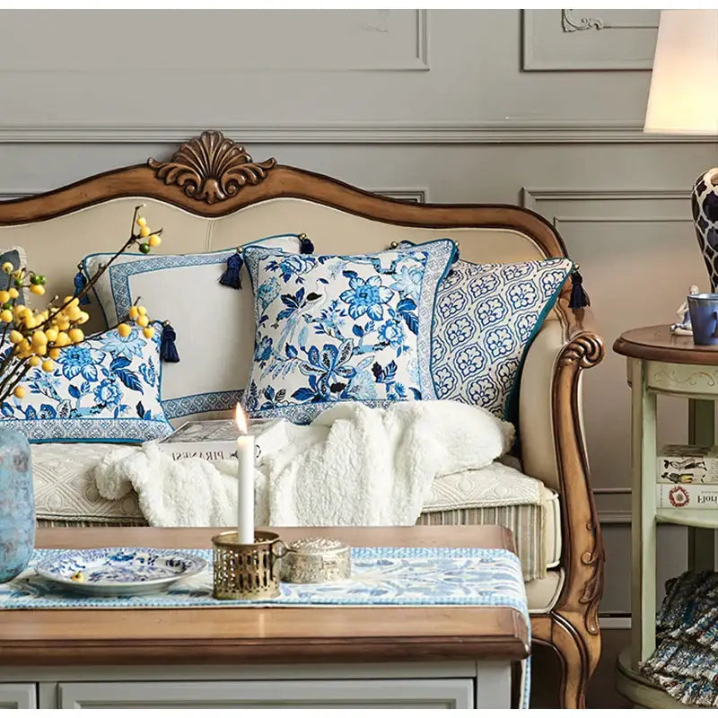 Blue and white floral patterned throw pillows with tassel trim.