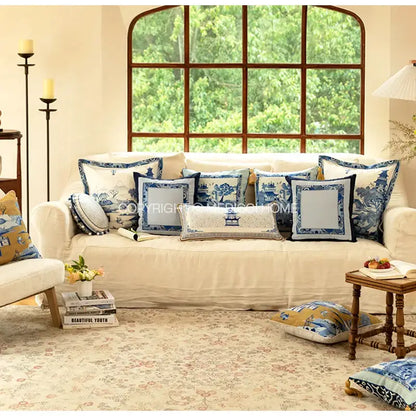 Cream-colored sofa with DecorBites™ chintz blue cobalt circular throw pillow covers featuring tassels and traditional designs