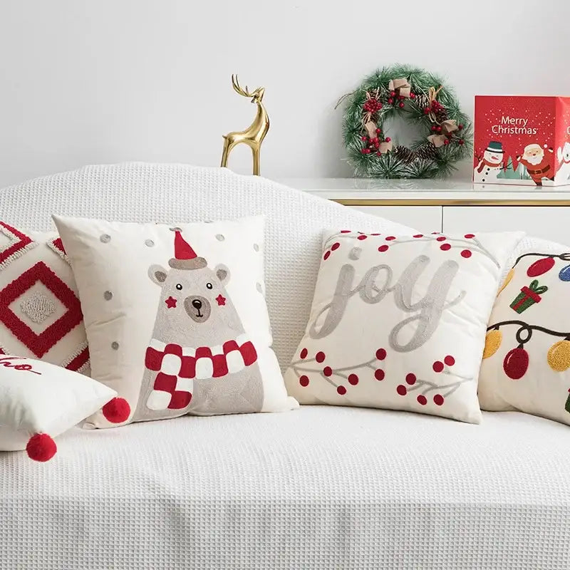White pillow cover with gray polar bear in red santa hat and scarf embroidered with red stars for decorbites christmas bell red collection
