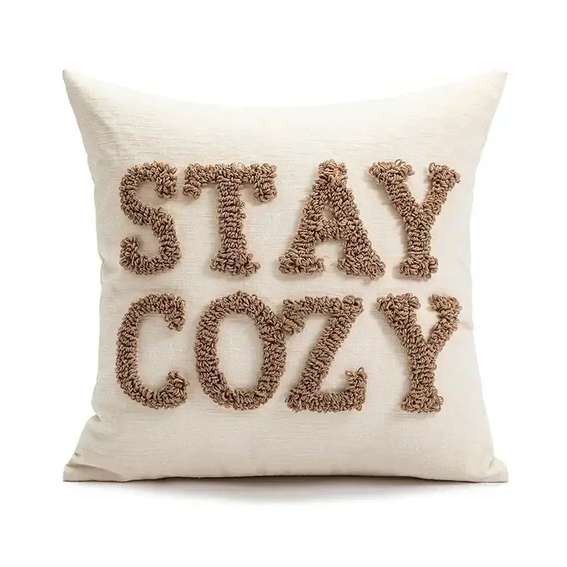 Cream-colored cushion cover with stay cozy embroidered in beige yarn for decorbites christmas cartoon candy design