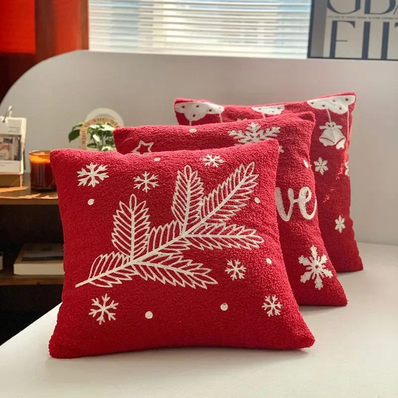Red plush embroidered pillow with white pine branches and snowflakes from decorbites christmas cartoon collection