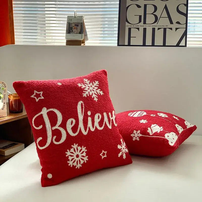 Red plush embroidered pillow with white snowflakes and believe script from decorbites christmas cartoon set