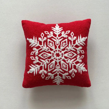 Red cushion featuring a white embroidered snowflake design from decorbites christmas cartoon embroidered pillow set