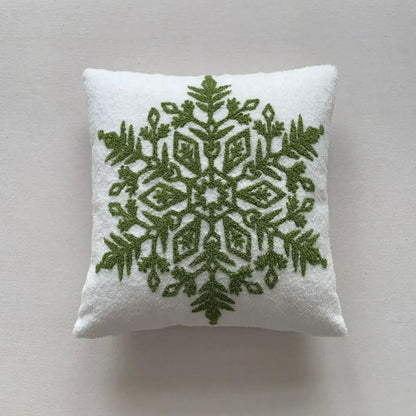 White plush pillow cover with intricate olive green embroidered snowflake design from decorbites christmas cartoon collection