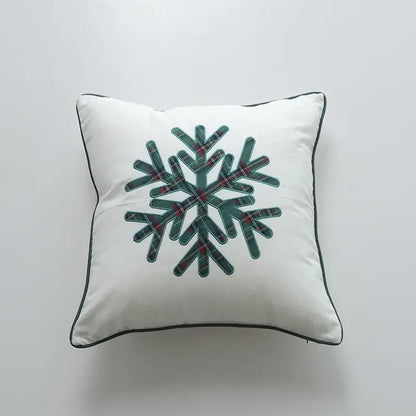 White square pillow cover with a central snowflake design in dark green and red plaid and black piping by decorbites christmas cartoon