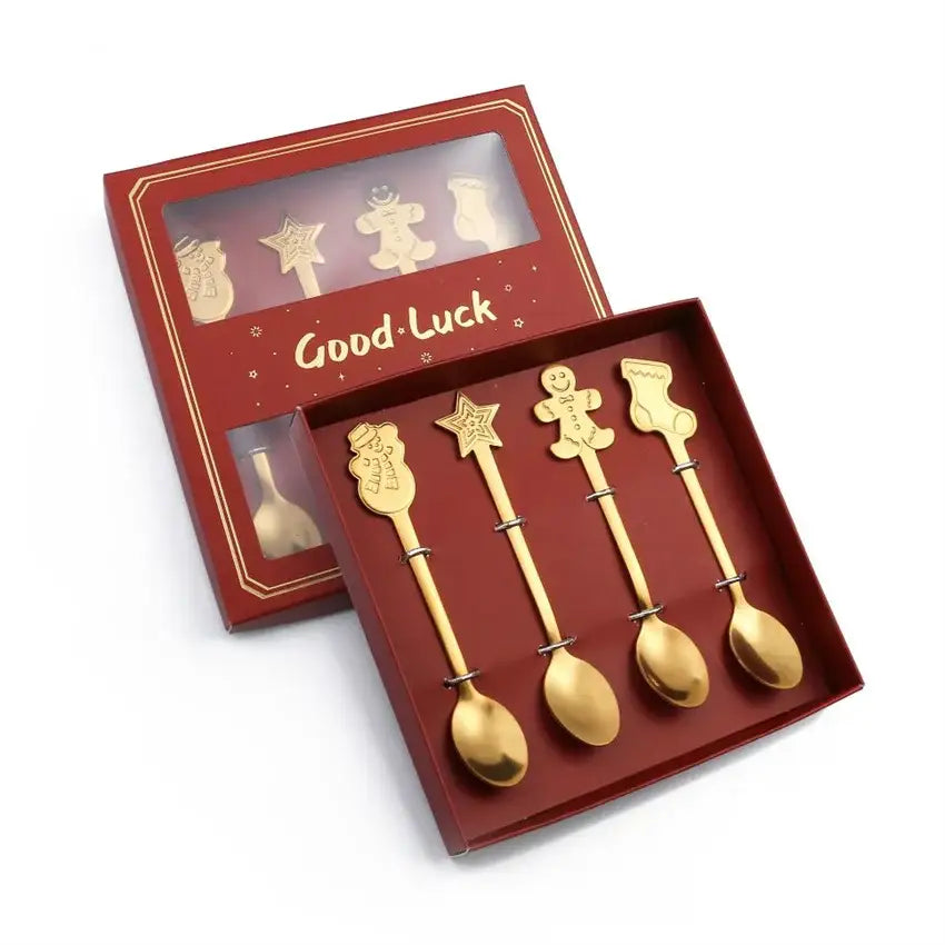 Set of five gold-colored stainless steel christmas coffee spoons with snowman star gingerbread man and stocking designs