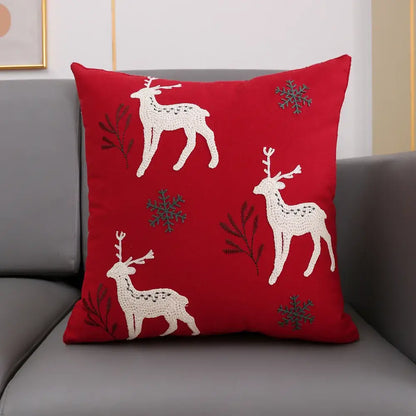 Red cushion cover with embroidered white reindeer and gray snowflakes from decorbites christmas décor collection