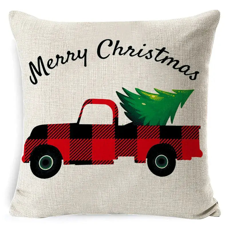 Beige linen pillow cover with a red and black plaid truck carrying a tree and merry christmas text by DecorBites christmas deer