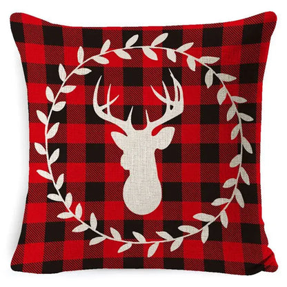 Red and black plaid linen pillow cover with white christmas deer silhouette framed by leaf wreath for home decorbites decor
