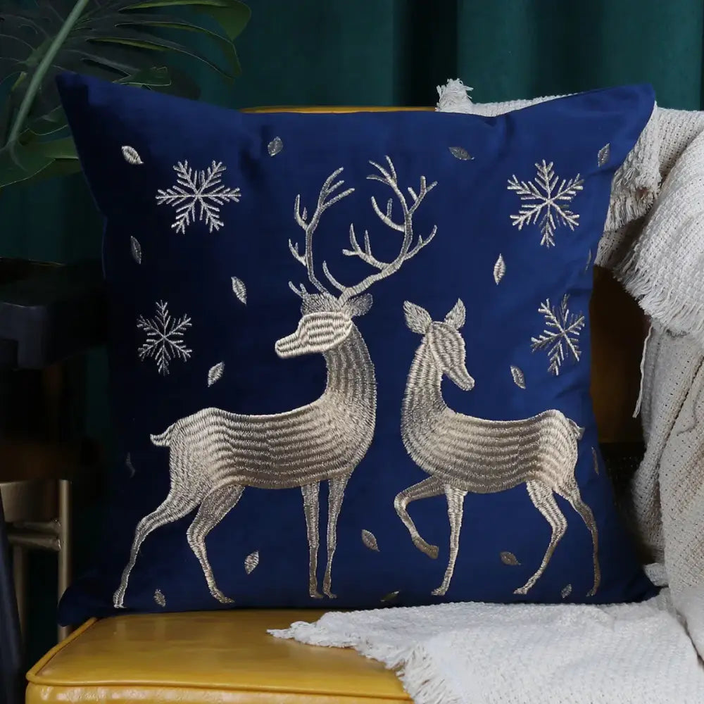 Deep blue velvet pillow covers with intricate silver embroidery of christmas elk and snowflakes by decorbites christmas elk