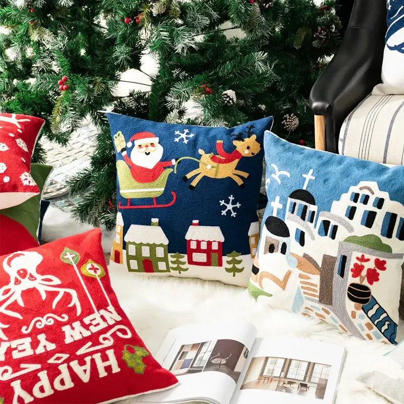 Blue pillow cover featuring decorbites christmas embroidered santa claus in sleigh over snowy houses design