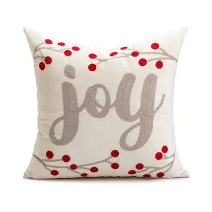 Cream-colored pillow cover with decorbites christmas embroidered joy in silver thread and red berry accents on gray branches