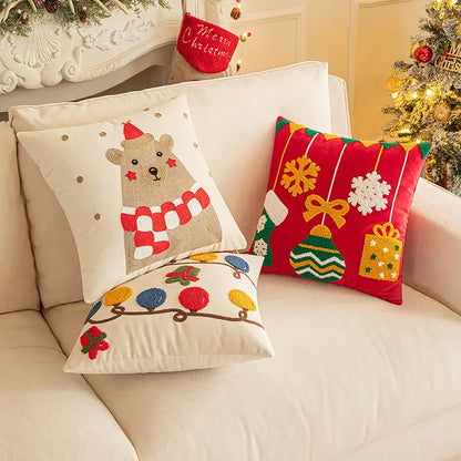Three festive decorbites christmas embroidered pillow covers featuring a beige bear, red geometric, and cream string lights design