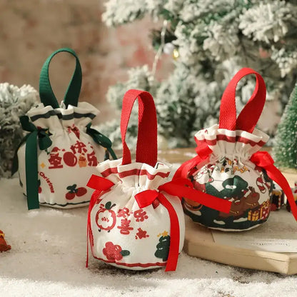 White fabric christmas eve apple bag by decorbites with red and green ribbons and festive drawstring top designs