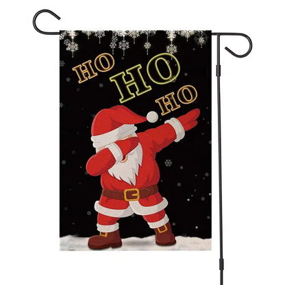 Black garden flag by DecorBites Christmas Festive featuring cartoon Santa dabbing with gold ho ho ho text on snowy background